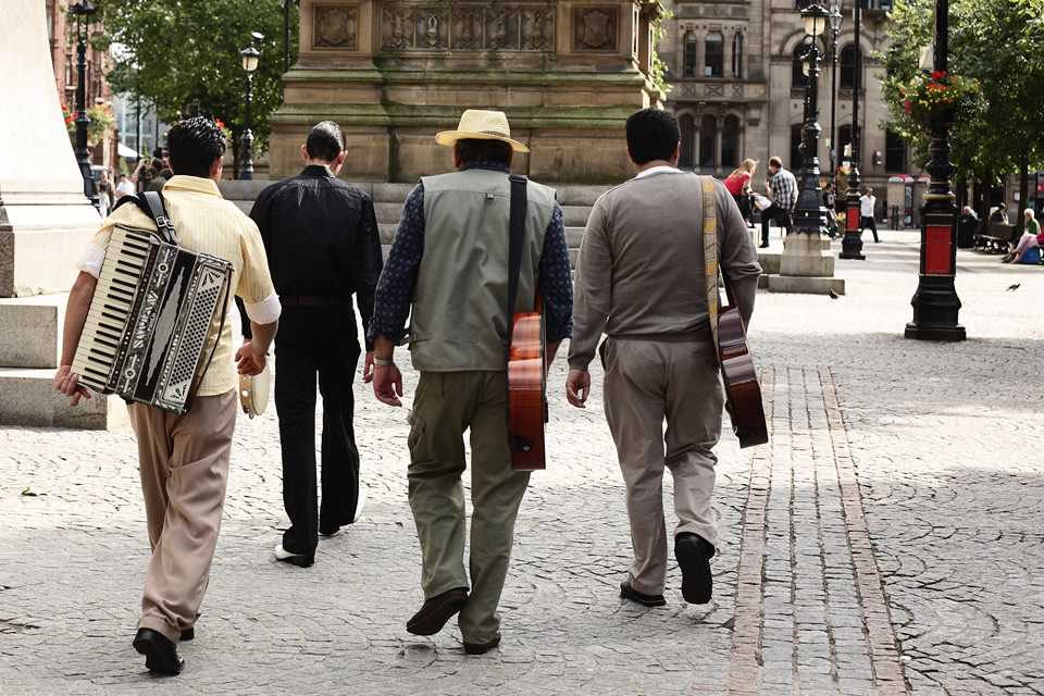 Musicians walking through Albert Square, Manchester