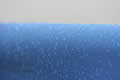 Rain drops on a blue plastic canvas
