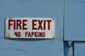 Fire exit sign on blue wooden door