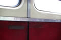 Red panelling and windows inside a train carriage